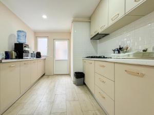 a kitchen with white cabinets and a sink at Pensiunea Riviera in Costinesti +13 photos
