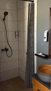 a bathroom with a shower with a shower curtain at LESS HOTEL Затока in Zatoka