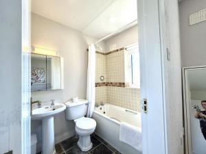 a bathroom with a sink and a toilet and a bath tub at Murlach Moorings in Ballyconneely +46 photos