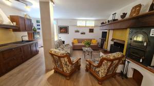 a living room with a couch and a fireplace at Villa Talciona in Poggibonsi