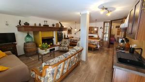 a living room with a couch and a fireplace at Villa Talciona in Poggibonsi