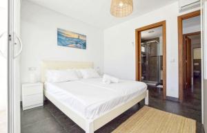 a bedroom with a white bed and a bathroom at Kanavayen Tres in Santanyi +18 photos