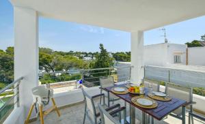 a dining room with a table and chairs on a balcony at Kanavayen Tres in Santanyi
