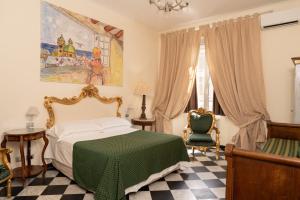 ein Schlafzimmer mit einem grünen Bett und einem Stuhl in der Unterkunft Morali Palace in Genua