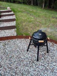 a grill sitting on top of a pile of gravel at Blackview cabin in Kulautuva