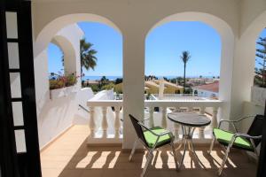 a balcony with a table and chairs and a view of the ocean at Charming Vila Van Gogh in Luz