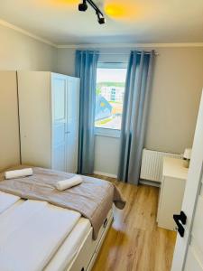 a bedroom with two beds and a large window at Zaczarowana Rotmanka in Rotmanka