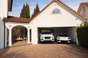 two cars parked in the garage of a house at Villa Löwe - Heated Indoor Pool, Spa & Wellness Estate near Basel in Kandern