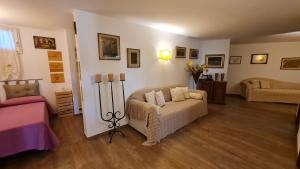 a living room with a couch and a chair at Villa Talciona in Poggibonsi +46 photos