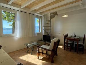 a living room with a couch and a table and a desk at Casa Caprice in Cannero Riviera