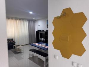 a room with a living room with a yellow wall at Bellamy in Porto Novo