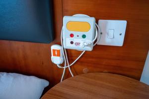a hotel room with an ipod charger and an ipod at Saram Lodge Lichfield in Lichfield