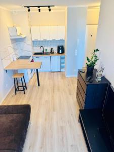 a kitchen with a table and a dining room at Zaczarowana Rotmanka in Rotmanka