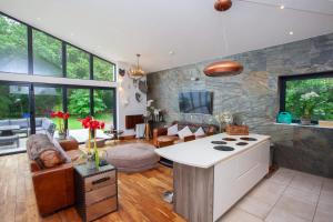 a kitchen and living room with a stove and a couch at Cameron North Lodge in Balloch