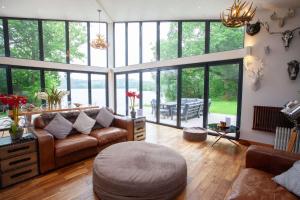 a living room with a couch and a table at Cameron North Lodge in Balloch