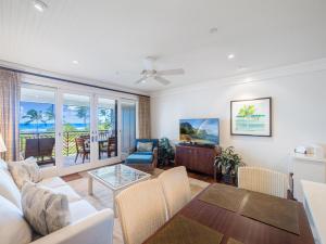 a living room with a couch and a table at Villa 302 at Turtle Bay in Kahuku