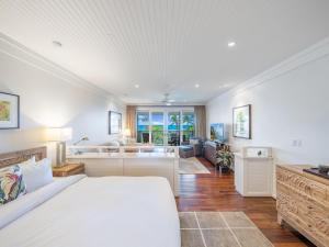 a bedroom with a bed and a living room at Villa 302 at Turtle Bay in Kahuku +42 photos