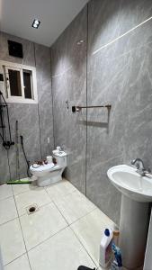 a bathroom with a toilet and a sink at Safety house in Tabuk +17 photos