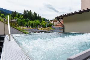 a swimming pool on the roof of a building at Hotel Cristallo in Andalo