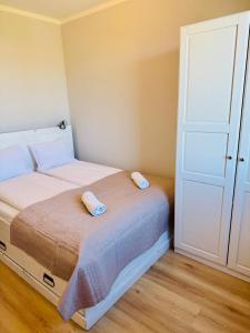 a bedroom with a bed with two pillows on it at Zaczarowana Rotmanka in Rotmanka