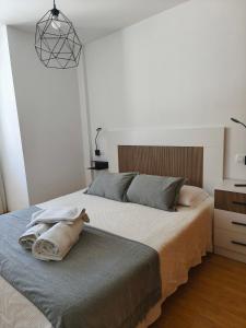 a bedroom with a bed with a towel on it at Piso en Cedeira in Cedeira