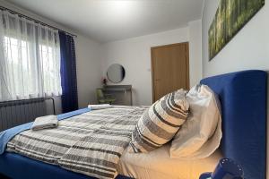 a bedroom with a bed with a pillow on it at ASGARD Guesthouse in Josipdol +21 photos