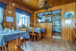 a dining room with wooden walls and tables and chairs at Penzion Slunečnice in Rokytnice nad Jizerou
