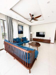 a living room with a couch and a ceiling fan at AnHuy Villa in Phú Quốc
