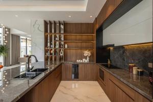 a large kitchen with a sink and a counter at AnHuy Villa in Phú Quốc