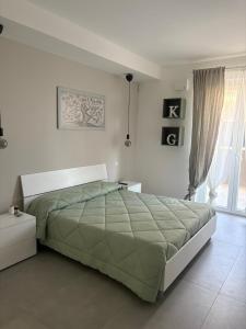 a bedroom with a large bed and a window at Sul Mare in Molfetta