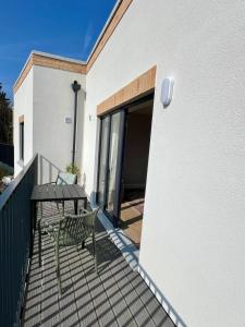 a patio with a table and a chair on a balcony at Hawthorn Stays in Maynooth