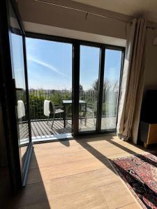 a room with a balcony with sliding glass doors at Hawthorn Stays in Maynooth