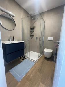 a bathroom with a shower and a sink and a toilet at Hawthorn Stays in Maynooth
