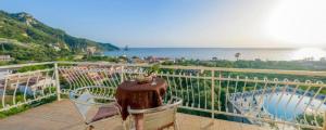 a balcony with a chair and a view of the ocean at Beach Oasis by BS- in Agios Gordios