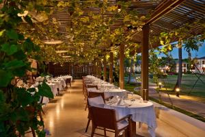 a row of tables in a restaurant with lights at Calabash Hotel in Saint Georgeʼs