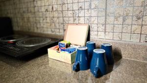a group of blue bottles on a counter next to a box at Deshco Oasis Suites, Alibaug in Chorondpāda +110 photos