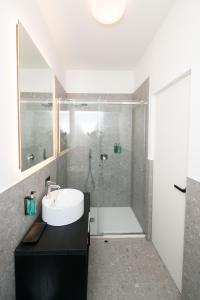 a bathroom with a sink and a shower at Albergo Canzo in Canzo