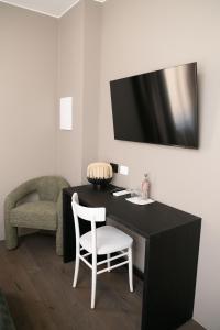 a black desk with a white chair in a room at Albergo Canzo in Canzo