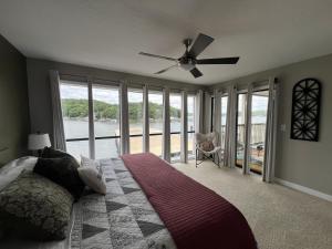 a bedroom with a bed and a ceiling fan at Baypoint Condo, Pool, Dock, relaxing location in Lake Ozark +22 photos