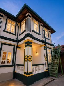 a white and black house with a ladder at Arvena Living in Jelutong
