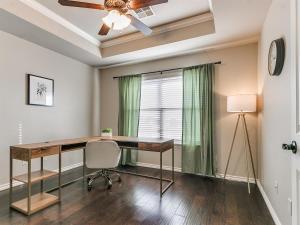 a home office with a desk and a ceiling fan at Where Comfort Meets Luxury in Yukon
