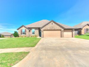 a large brick house with a garage at Where Comfort Meets Luxury in Yukon