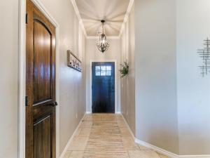 a hallway with a black door and a chandelier at Where Comfort Meets Luxury in Yukon +40 photos