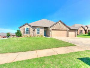 a house with a large yard with a driveway at Where Comfort Meets Luxury in Yukon