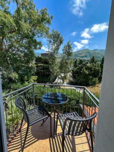 a patio with two chairs and a table on a balcony at Beach House - Affittacamere Paola in Paola