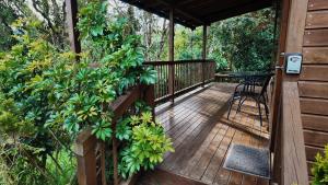 a wooden deck with a table and chairs on it at MAGDA Nature Lodge in El Retiro