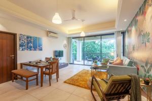 a living room with a couch and a table at Deshco Oasis Suites, Alibaug in Chorondpāda