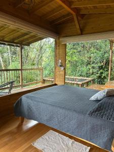 a bedroom with a large bed on a balcony at MAGDA Nature Lodge in El Retiro