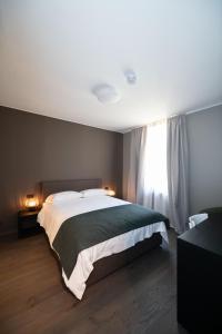 a bedroom with a large bed and a window at Albergo Canzo in Canzo