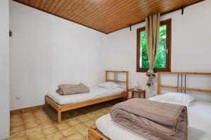 two beds in a room with two windows at 10. cerisiers option clim- 4 pers in Calviac